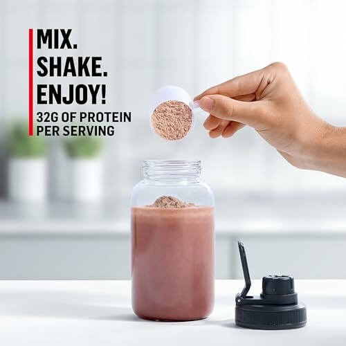 Protein shake preparation with scoop and bottle.